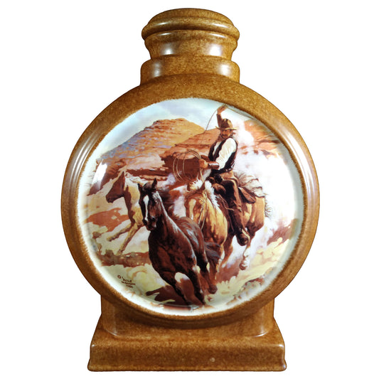 A beautiful large sized cremation ceramic urn with a decoration of a cowboy attempting to rope a horse on a desert scene. Front View