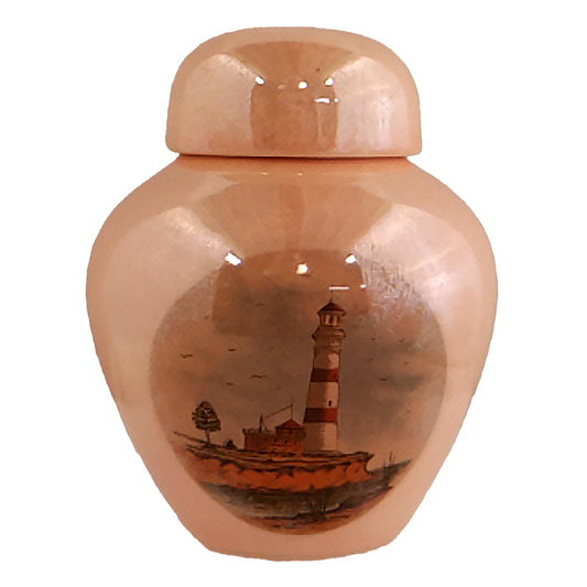 Keepsake urn with a picture of a lighthouse on the seashore, finished with mother-of-pearl lustre.