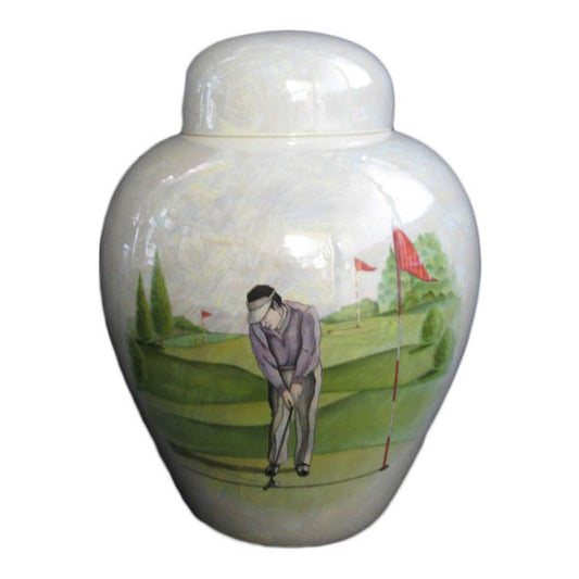 A beautiful medium sized cremation ceramic urn with a decoration of a scene of a man putting on a golf green with a mother-of-pearl finish.