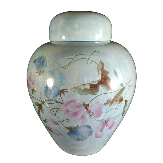 A beautiful medium sized blue cremation ceramic urn with a decoration of flowering sweetpea with a mother-of-pearl finish.