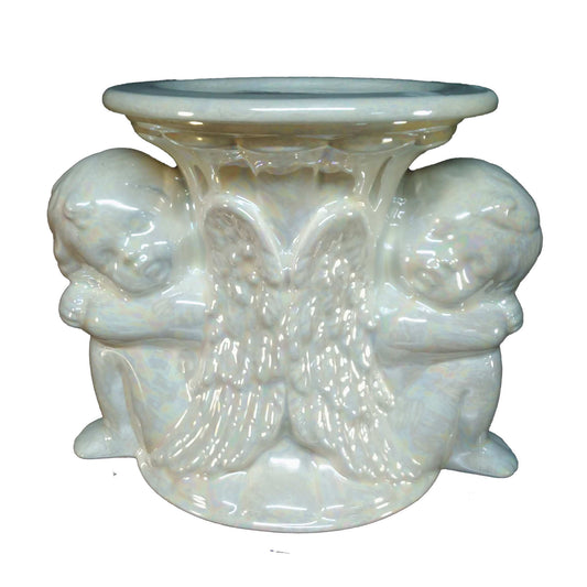 A beautiful large-sized cremation ceramic keepsake urn with two restful cherubs back-to-back at the base and a plate on top to place a candle with a mother-of-pearl finish
