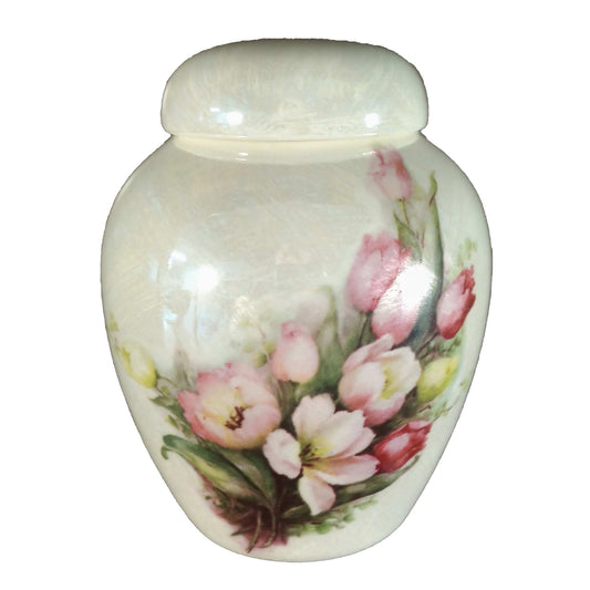 A beautiful small-sized cremation ceramic keepsake urn with a decoration of a bouquet of tulips with a a mother-of-pearl finish.