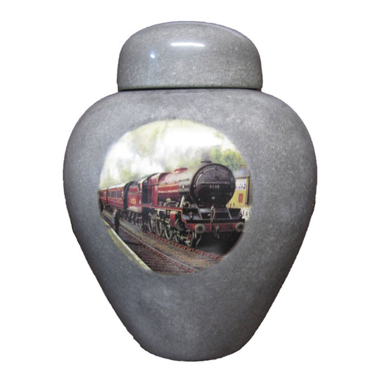 A beautiful medium-sized cremation ceramic urn with a decoration of a steam train with a granite-look finish.