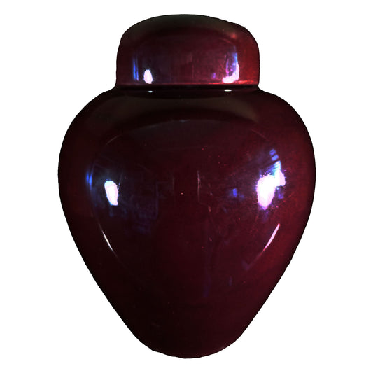 A beautiful medium sized cremation ceramic urn with a gloss dark cherry coloured finish.