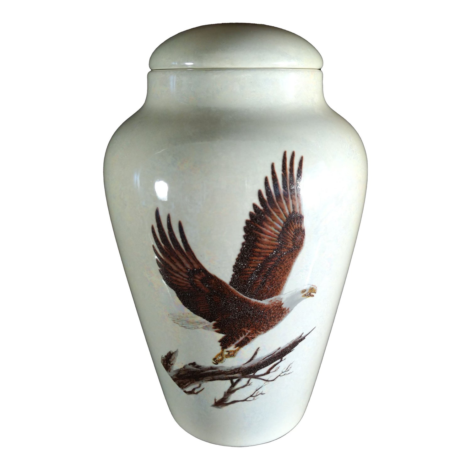 A beautiful medium sized cremation ceramic urn with a decoration of a bald eagle taking flight from a tree limb with a mother-of-pearl finish.