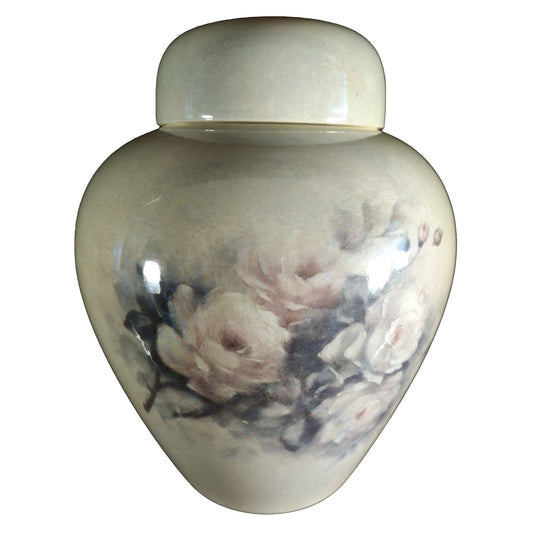 A beautiful medium sized cremation ceramic urn with a decoration of a fading rose bouquet with mother-of-pearl finish. Front View