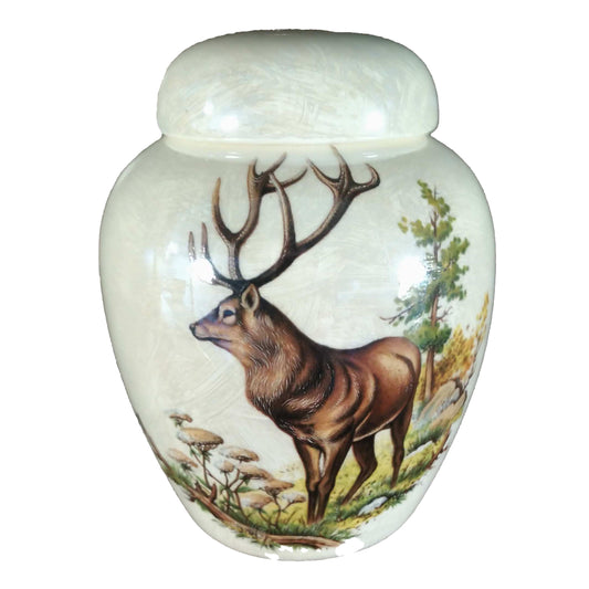 A beautiful medium-sized cremation ceramic keepsake urn with a decoration of a elk stag in a treed setting with a mother-of-pearl luster finish.