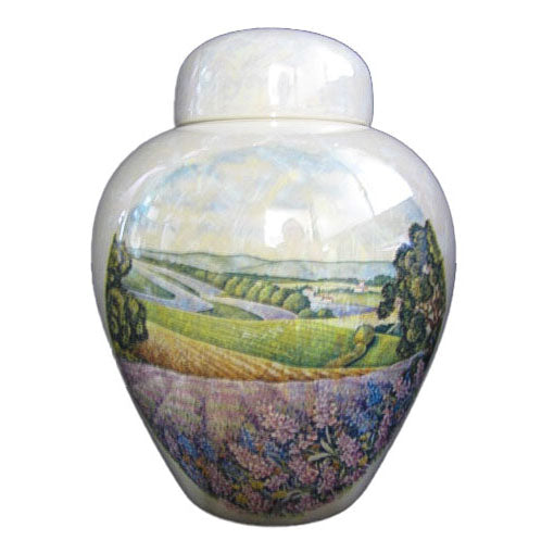 A beautiful medium sized cremation ceramic urn with a decoration of a scene of lavender fields with a mother-of-pearl finish.