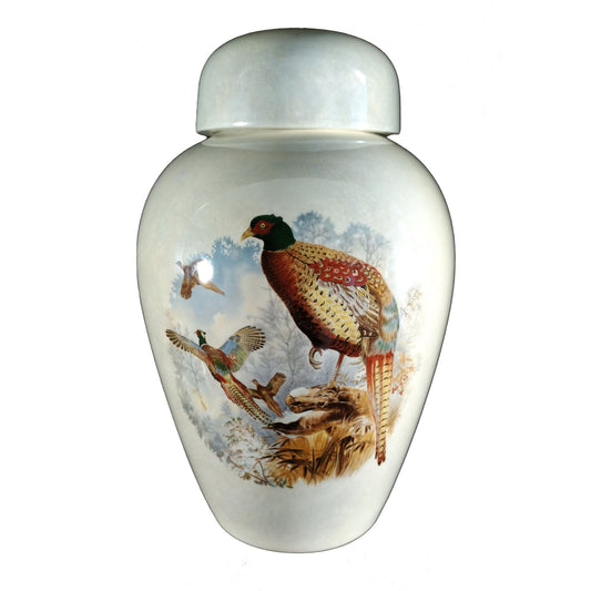 A beautiful medium sized cremation ceramic urn with a decoration of a scene of pheasants with a mother-of-pearl finish.