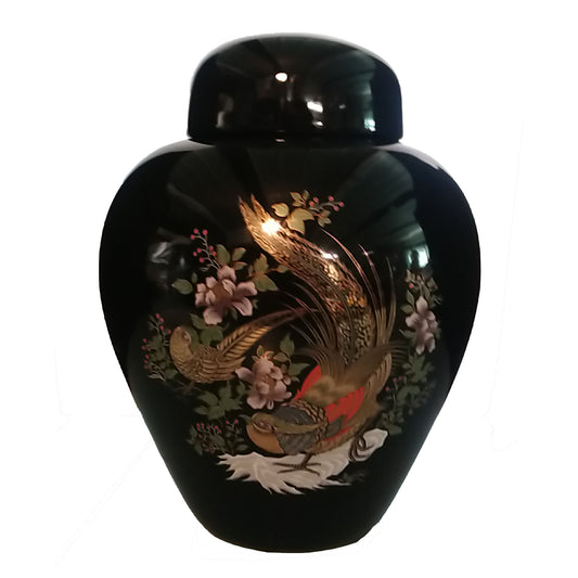 A gloss black cremation urn with a picture decoration of two pheasants with gold highlights.