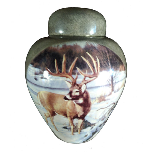 A beautiful medium sized cremation ceramic urn with a decoration of a antlered white-tailed deer in a winter landscape scene and granite-look finish. Front View